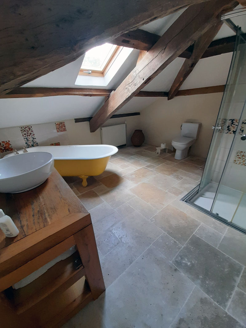 bathroom with sloped ceilings and oak beams