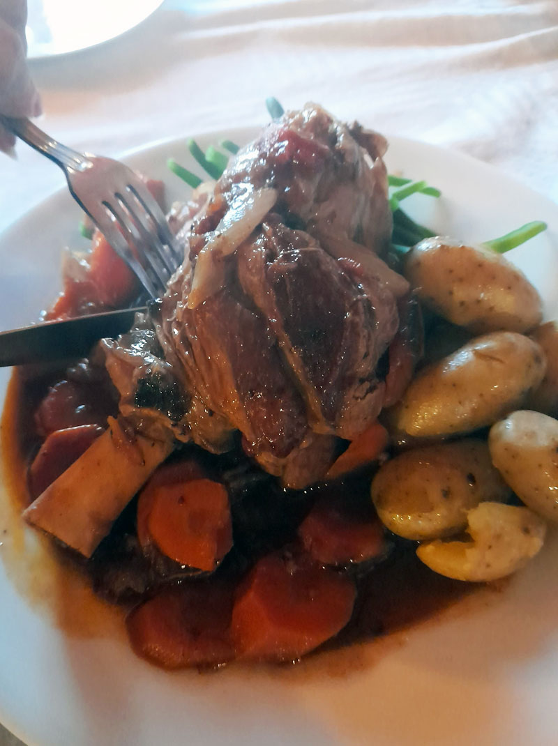 delicious roast lamb dinner with potatoes, vegetables and gravy
