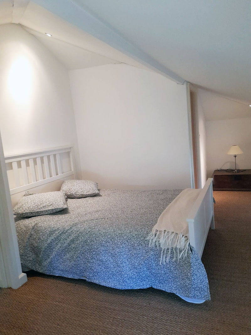 bright white airy bedroom with double bed
